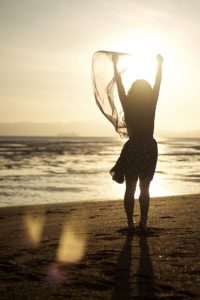 Woman cheering on beach